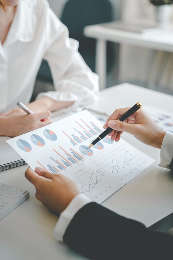 Teamwork with price chart analyzes business people on the table at the conference room.