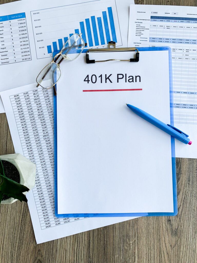 Paper with 401k plan on wood table.